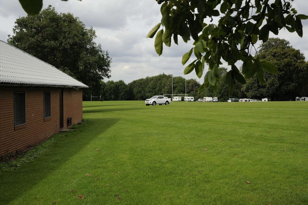 Travellers driving across playing fields