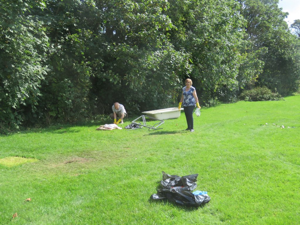 Trustees picking up rubbish left by the Trustees